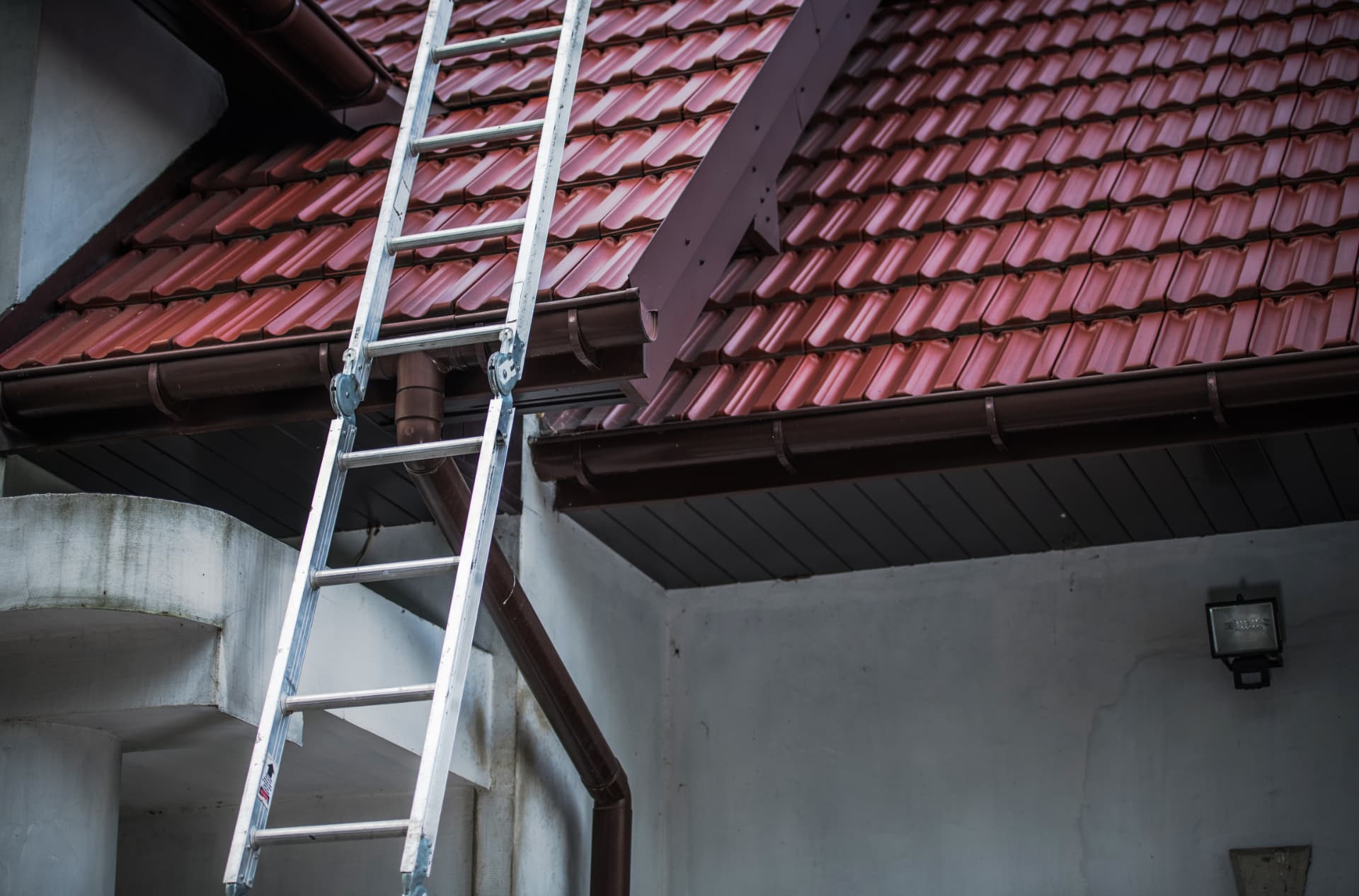 A ladder positioned for a roof inspection
